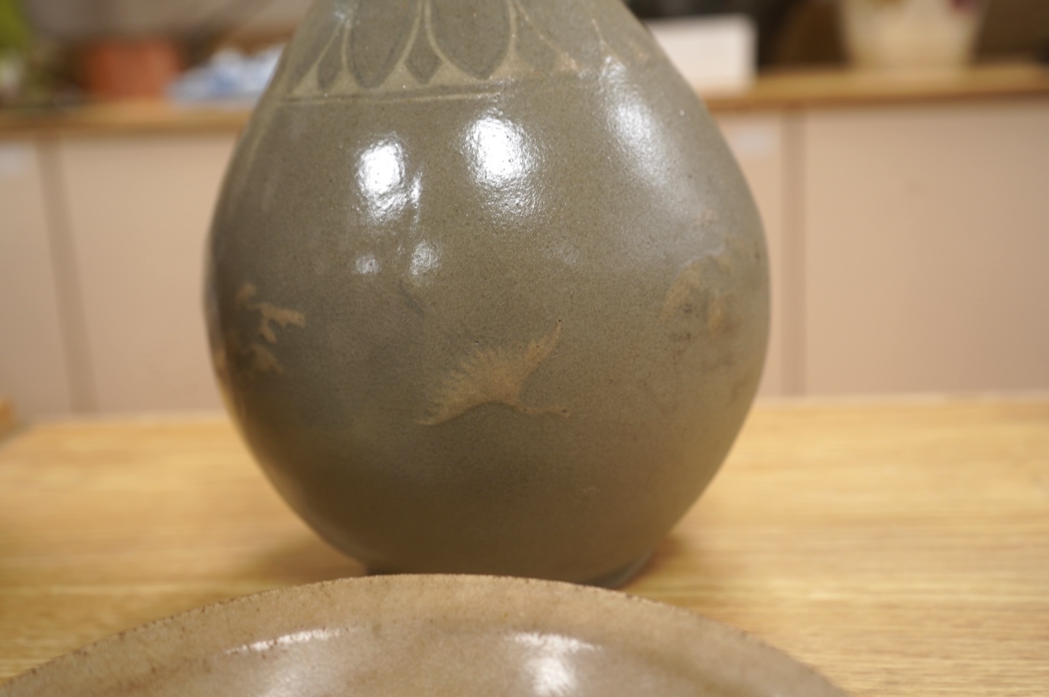 Five pieces of Chinese/Korean celadon comprising three bowls and two vases, 31cm high. Condition - some breaks